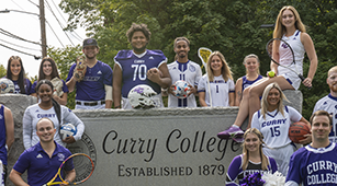 ˮƵ College Athletes pose for a photo at the front gate